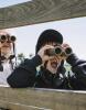 3 Children look through binoculars.